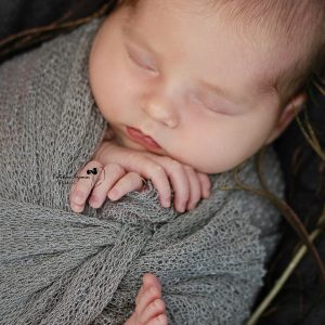 Newborn photography sessions and studio newborn photography shoots. Newborn photo shoot comes with posing, props, and edited photos on a flash drive.