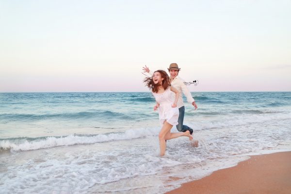 Love story, engagement photography and proposal portraits in a beach or a park environment.