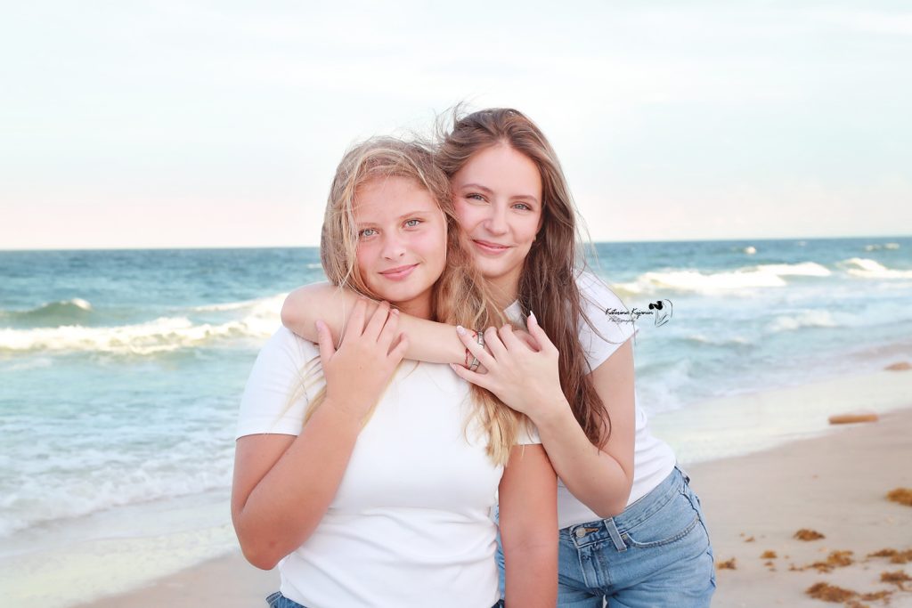 Family enjoying a joyful beach photography session, capturing candid moments of love, laughter, and togetherness by the ocean at sunset.