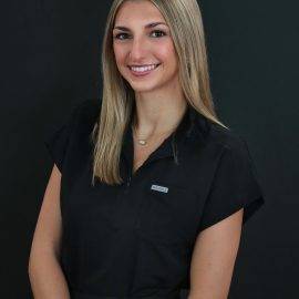 Professional studio headshot portrait of a woman photographed against a black background at a Palm Coast, Florida photography studio.