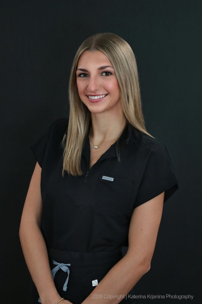 Professional studio headshot portrait of a woman photographed against a black background at a Palm Coast, Florida photography studio.
