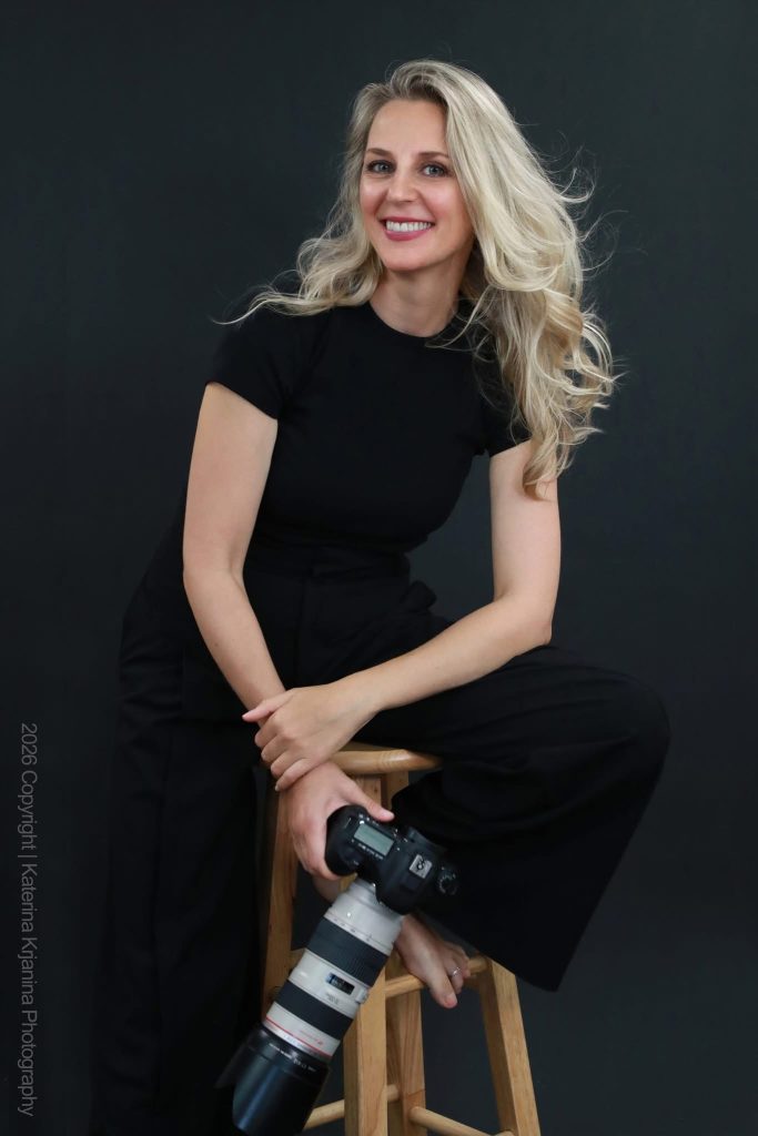 Professional studio headshot portrait of photographer Katerina Krjanina photographed against a black background at a Palm Coast, Florida photography studio.